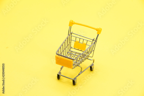  Yellow shopping trolley cart on Yellow background 
