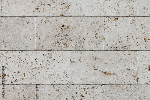 Natural Italian stone. Smooth travertine surface. A sample of wall cladding with natural stone.	