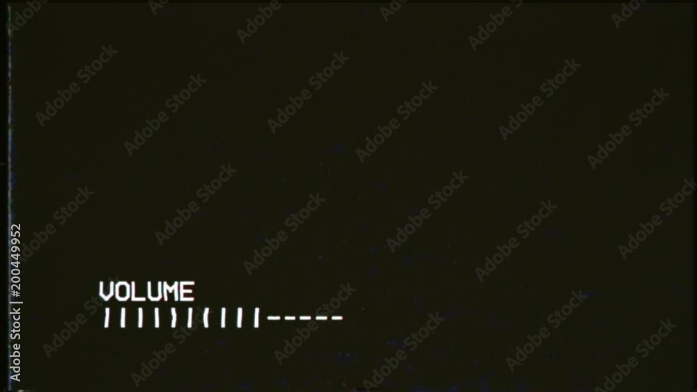 Turning up the volume on an old VCR player, showing a blank VHS tape playing. A vintage background for videos, a retro element.
