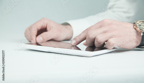 Man using white digital tablet.