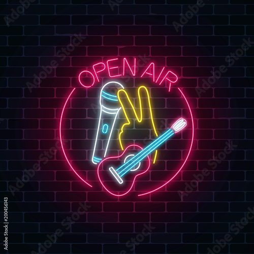 Neon open air sign with microphone, guitar and piece gesture in round frame. Live music in open air icon.