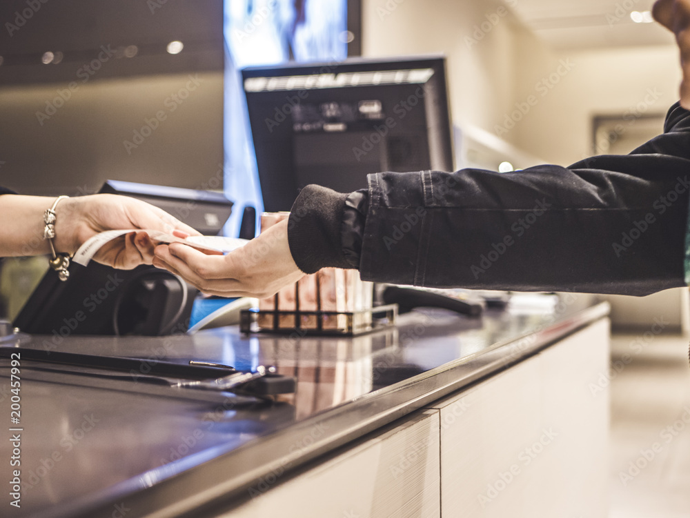 person in the shop paying with cash and wallet close up