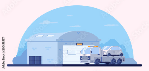 Garage for storage and parking of cars. Car repair shop. Lorry wrecker with faulty car on platform. Road service.