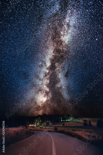 Milky Way galaxy over the forest and road. Milky Way galaxy over the mountain forest and road, Rajac, Serbia. The night sky is astronomically accurate. photo