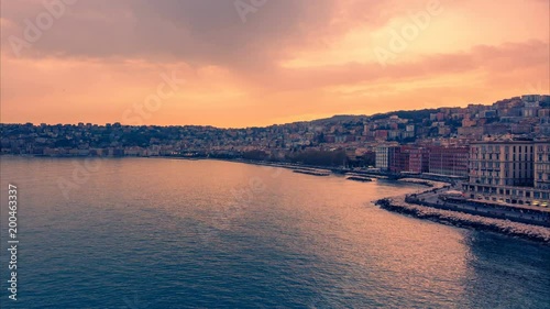 Naples, Italy. View of Posillipo from Castel Dell'ovo and Via Partenope in Naples at sunset. Time lapse. Zoom out effect photo
