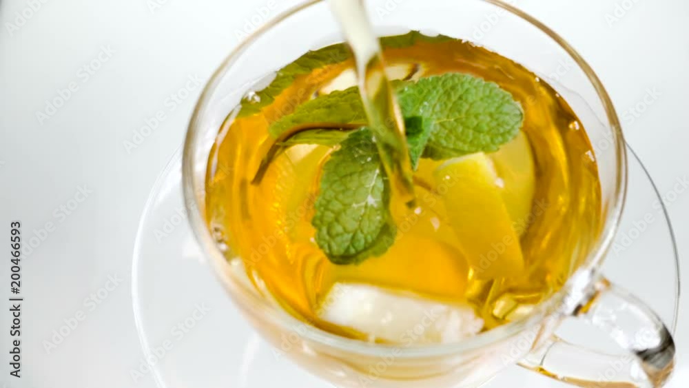 tea in cup with leaf mint and lemon on white background tea in cup with leaf mint and lemon on white background
