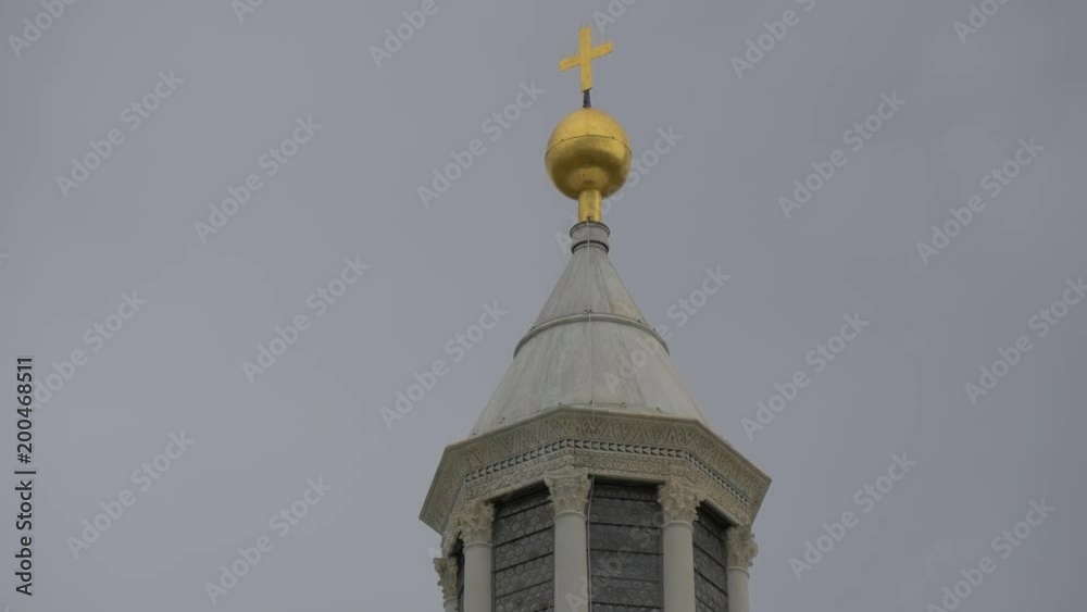 A gilded globe and cross on a roof top A gilded globe and cross on a roof top