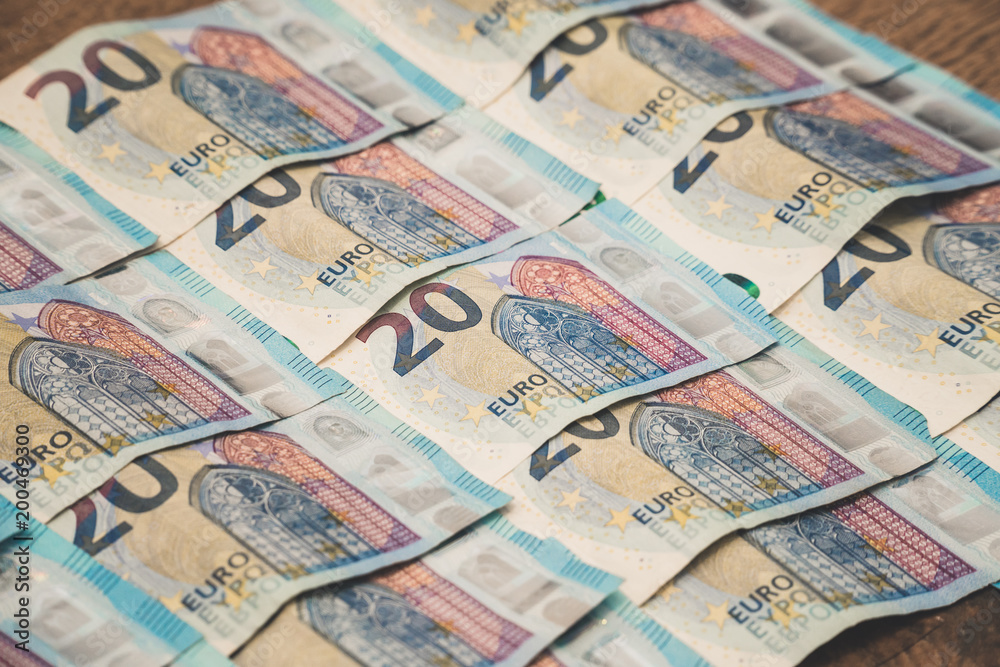 Fototapeta premium A close up of few twenty-euro bills are lined up on the ground.