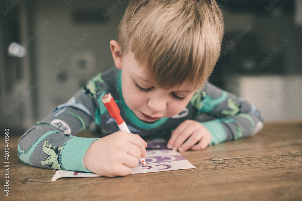 Young boy writing his ABCs at home Young boy writing his ABCs at home