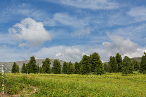 Beautiful blue sky with clouds over the top of Altai Mountains. photo