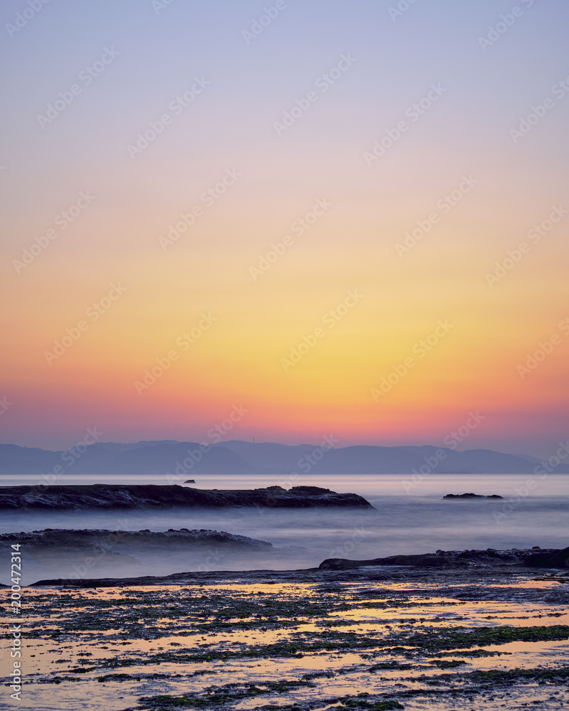 Sunrise light over wet searocks in Enoshima, Kanagawa Prefecture, Japan