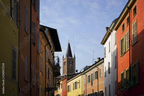 Narrow colourful alley on a sunny Winter day, Parma, Italy