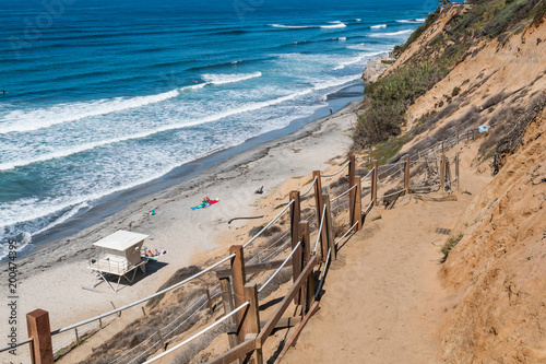 A dirt trail leading toward the beach and a lifeguard station at Beacon's Beach in Encinitas, California. © sherryvsmith