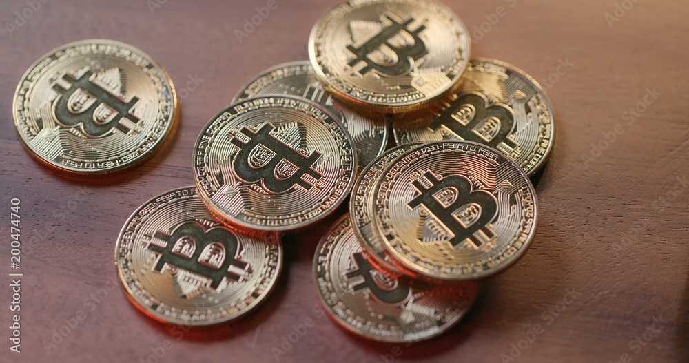 Heap of gold bitcoin on table