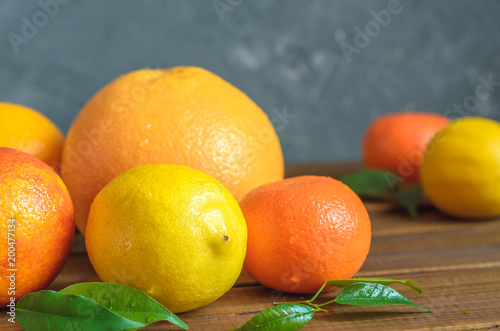 Fresh citrus fruits on wooden table. © Maksim
