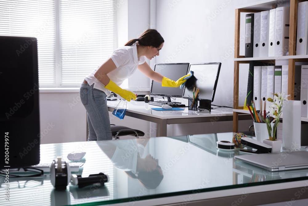 Woman Cleaning Computer In Office - obrazy, fototapety, plakaty 