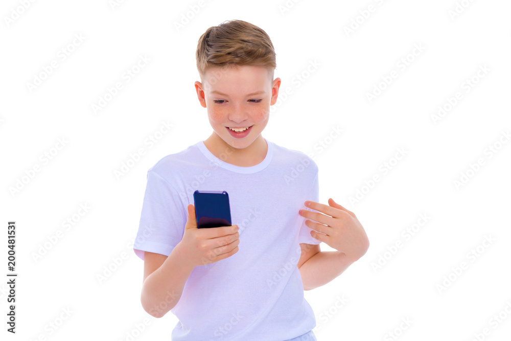 A little boy uses a mobile phone. A little boy uses a mobile phone.