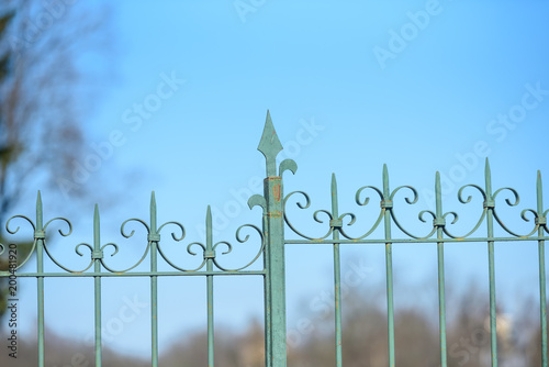 forged metal fence of the Park on the sky background