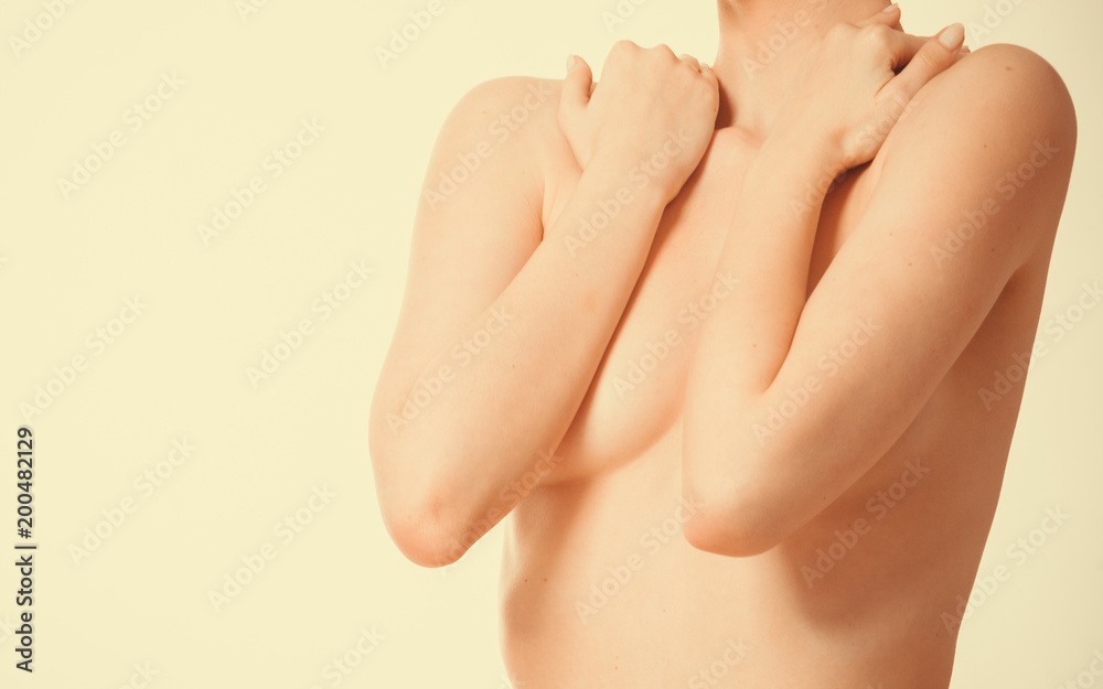 Fototapeta premium Woman covering her breast with hands