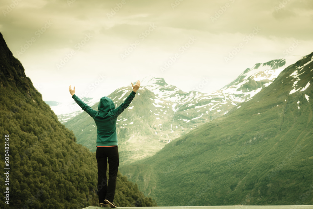 Tourist woman enjoying mountains landscape in Norway.
