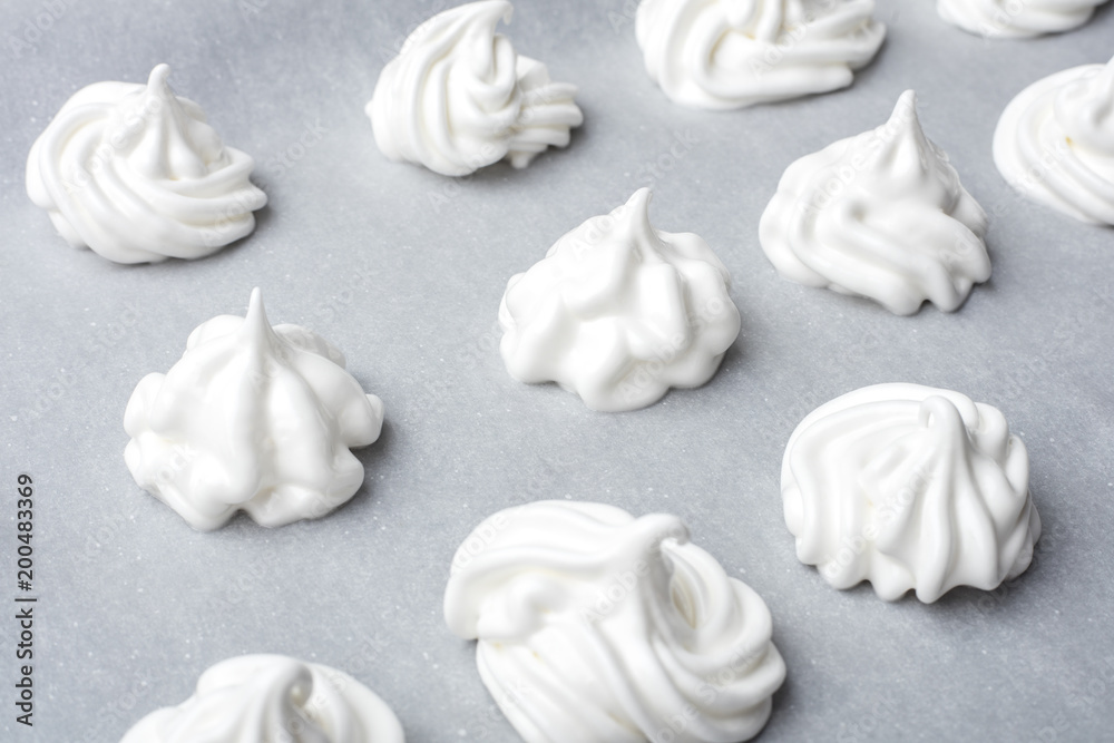 Whipped cream on baking paper. Meringue of the proteins and sugars. Step-by-step recipe for meringue cookies. Process of meringue preparation Whipped cream on baking paper. Meringue of the proteins and sugars. Step-by-step recipe for meringue cookies. Process of meringue preparation