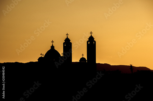 silhouette of the Coptic church on sunset background