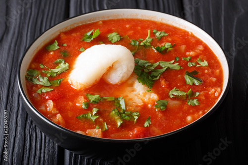 Fish soup with tomatoes, celery, onions, garlic and parsley close-up in a bowl. horizontal