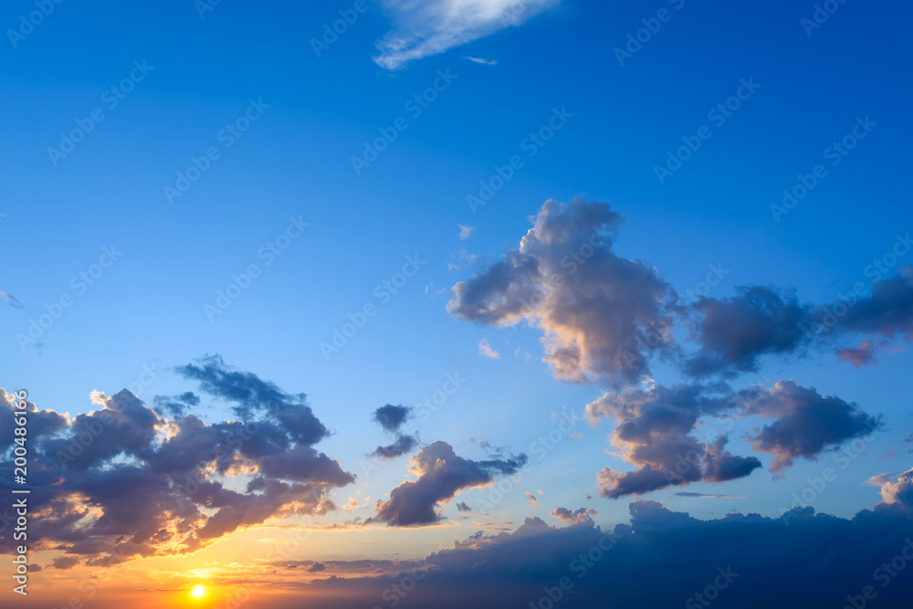 Beautiful blue sky with clouds and setting sun