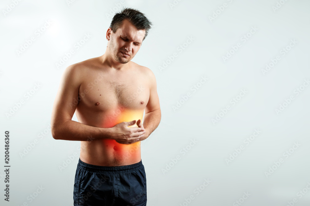 Front view, the man holds hands for his side in the liver's rena, liver