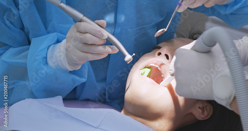 Woman examining teeth at dental office