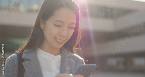 Photography Asian Business woman use of mobile phone at city in the evening