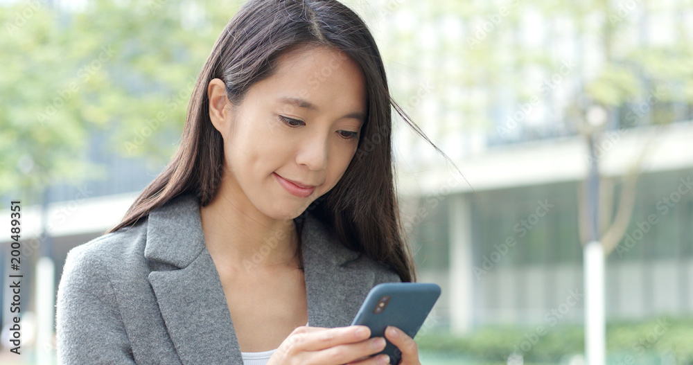 Business woman use of mobile phone in Hong Kong city