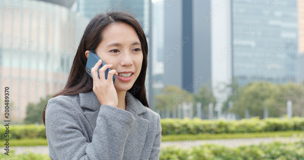 Businesswoman talk to mobile phone at outdoor Businesswoman talk to mobile phone at outdoor