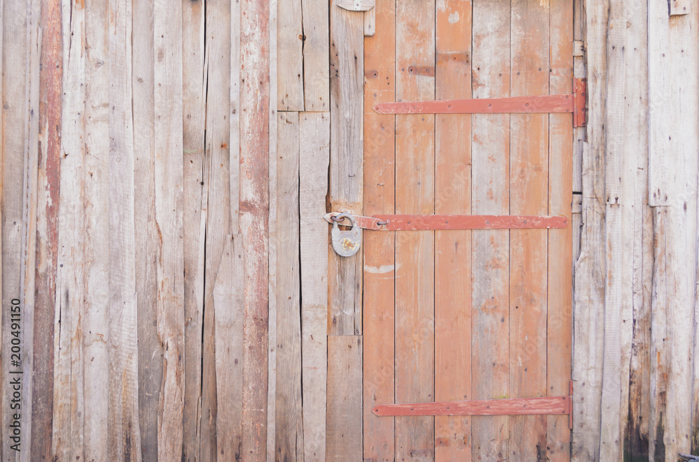 Grey wooden wall from old boards with door Grey wooden wall from old boards with door