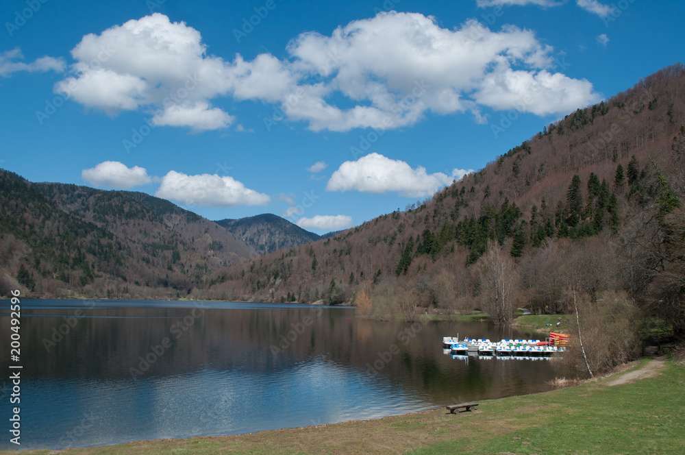 panorama of lake of Kruth with pedalos ans beautiful cloudy sky in alsace - France