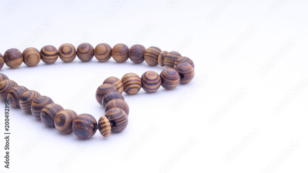 Closeup of tasbih or rosary on a white background. Selective focus and copy space. Closeup of tasbih or rosary on a white background. Selective focus and copy space.