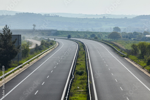 Highway traffic in sunset with cars and trucks