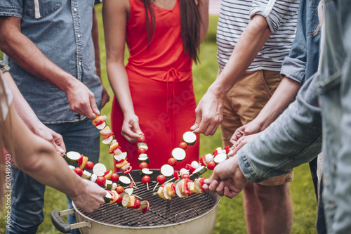 Group of friends grilling shashliks photo