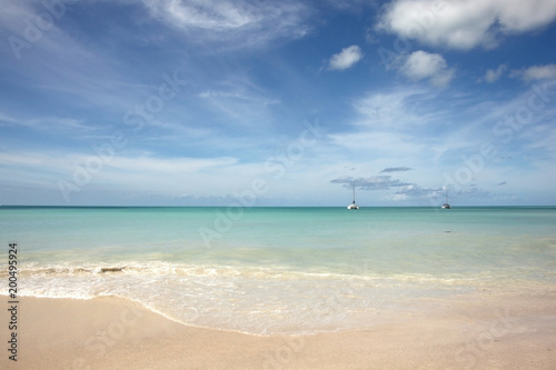 Out to sea with a view over a beautiful beach in Antigua, Caribbean.
