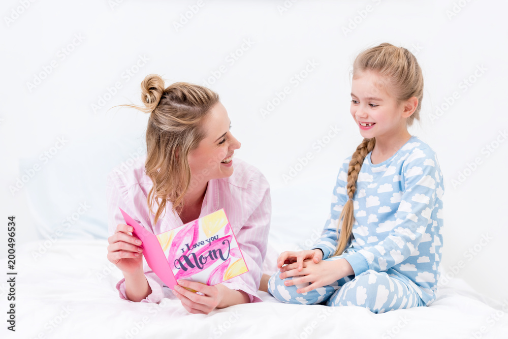 happy mother holding postcard from daughter on happy mothers day happy mother holding postcard from daughter on happy mothers day