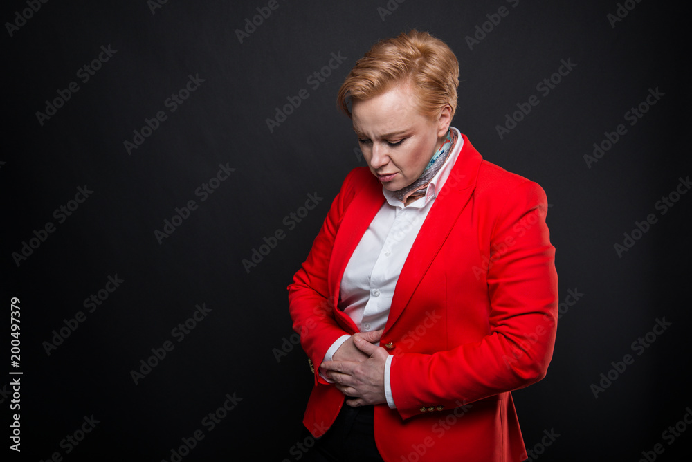 Portrait of attractive business woman holding stomach like hurting