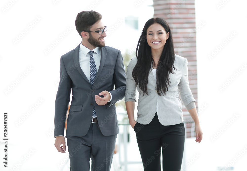 employees of the company discuss working issues standing in the office employees of the company discuss working issues standing in the office
