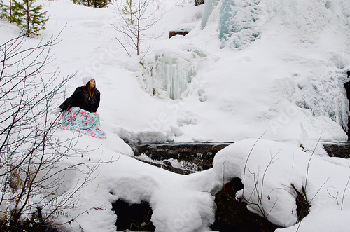 beautiful girl at the winter waterfall