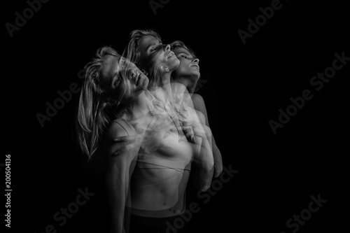 Emotional creative phantom portrait of young blonde woman. Black and white photo. triple exposure.