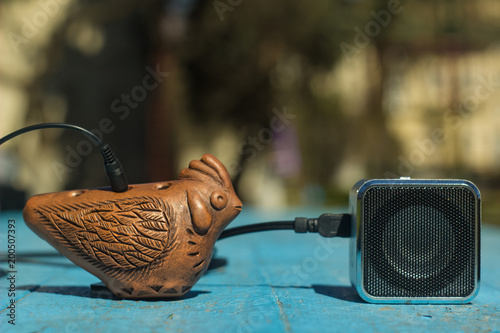 evolution and development concept with okarina handmade music folk instrument and loud speaker photo