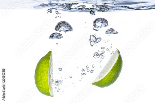 Fresh lime fruit water splash with bubbles
