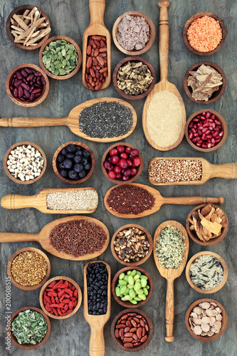 Fototapeta Naklejka Na Ścianę i Meble -  Healthy food concept with legumes, fruit, grains, cereals, medicinal herbs and spice. Foods high in omega 3 fatty acids, antioxidants, anthocyanins, minerals, vitamins and dietary fibre. Top view.