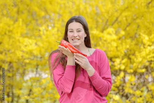 Beautiful attractive young woman holding healthy detox vegetable. Healthy lifestyle concept.