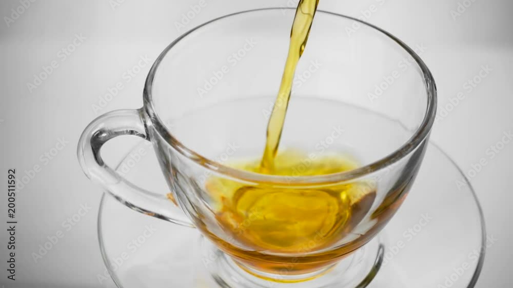 Green tea. Pouring tea into a glass cup. Slow motion. High speed camera shot. Full HD 1080p Green tea. Pouring tea into a glass cup. Slow motion. High speed camera shot. Full HD 1080p
