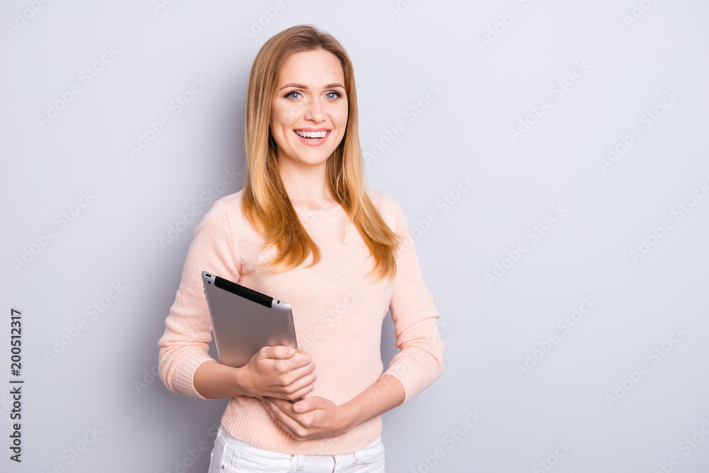 Portrait of excited cheerful joyful beautiful charming clever intelligent with toothy beaming smile marketer using digital tablet for her presentation isolated on gray background copy-space Portrait of excited cheerful joyful beautiful charming clever intelligent with toothy beaming smile marketer using digital tablet for her presentation isolated on gray background copy-space